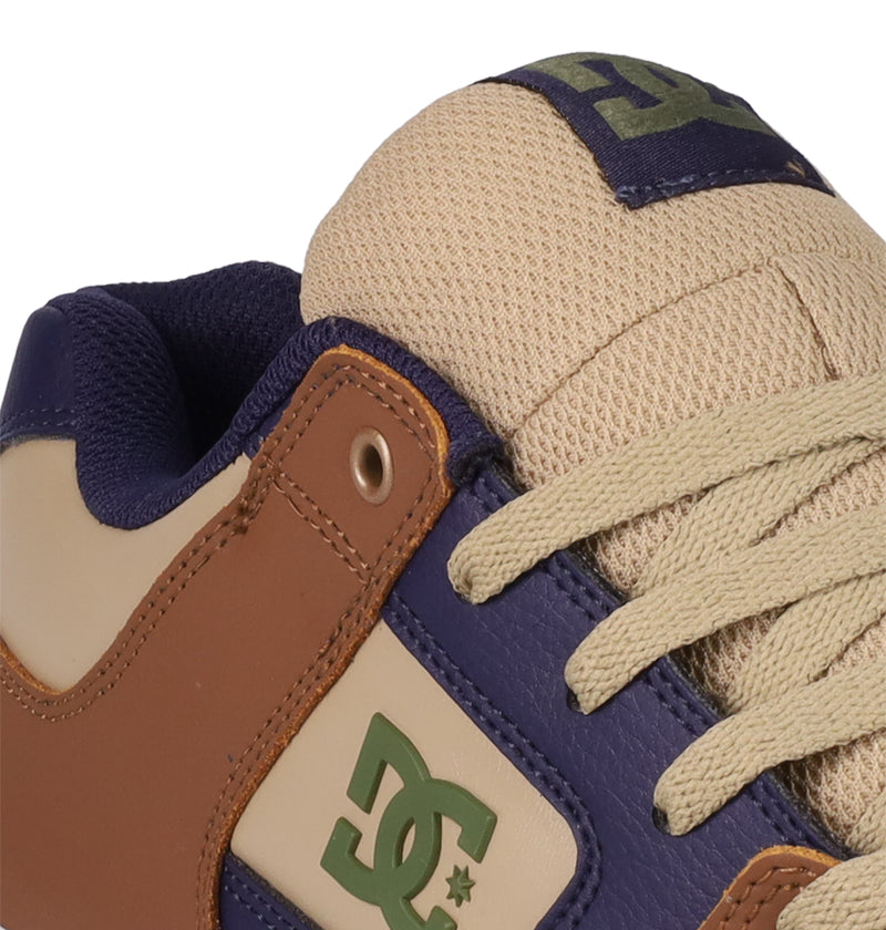 Close-up of DC Shoes Men's Pure Shoes with tan laces, purple and brown overlays, a cream mesh upper, and green DC Shoes logos on the side and tongue.