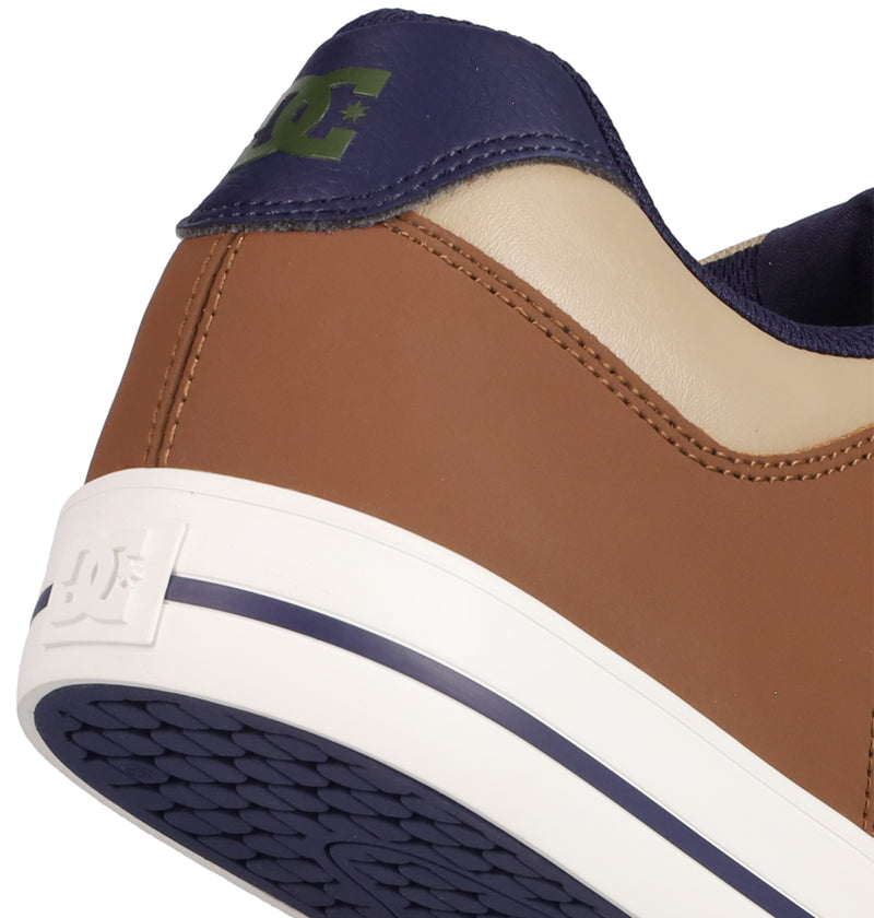 Close-up of the heel of DC Shoes Men's Pure Shoes featuring brown, beige, and navy panels, a navy tread, white sole with an embossed DC logo, and a green DC logo on the upper heel.