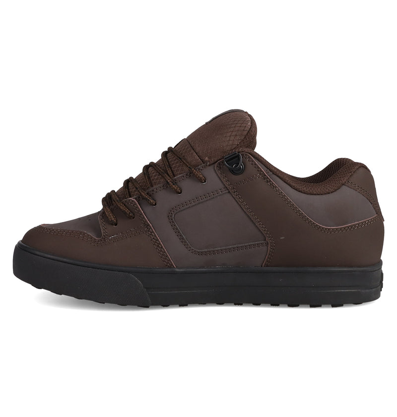 The DC Shoes Men's Pure Shoes, shown in side profile on a white background, feature a brown low-top design with a black rubber sole, rounded toe, brown laces, padded tongue and collar for comfort and versatile style.