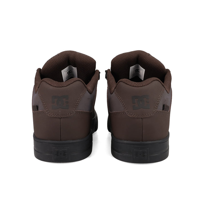 A pair of brown DC Shoes Men's Pure Shoes are shown from the back, displaying black soles and the DC logo on the heel tabs—ideal for daily comfort and style.
