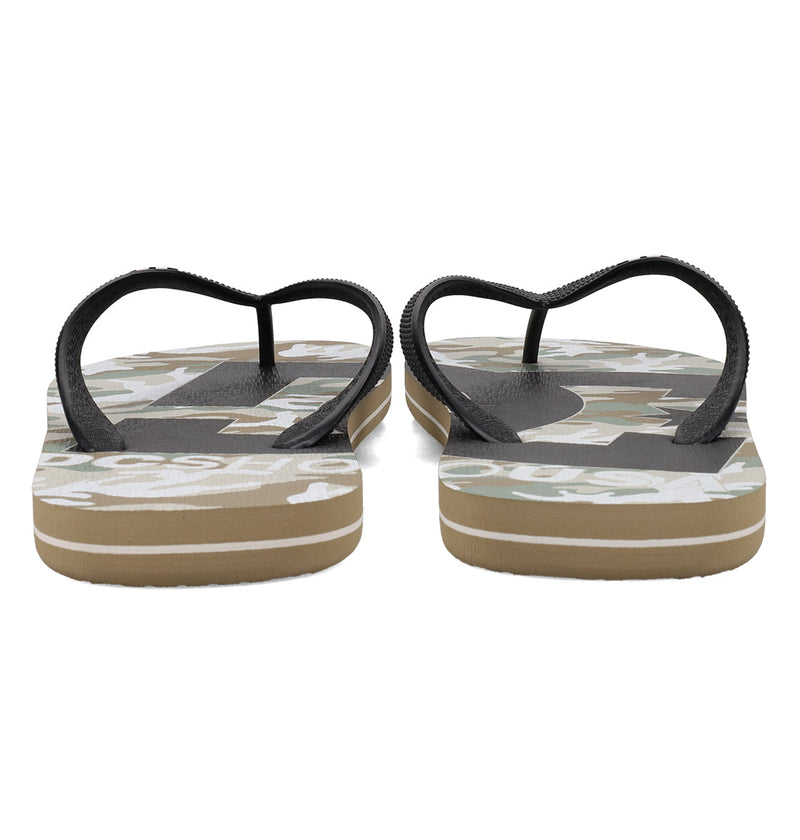 The DC Shoes Men's Spray Graffik Slides feature black straps and a camo-patterned footbed, shown from the back highlighting the soles and top design—ideal for slipping on after a skate session.
