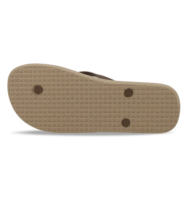The image shows the bottom view of DC Shoes Men's Spray Graffik Slides with a beige sole, grid-like tread, and three circular textured areas—delivering ideal traction for your next skate session.