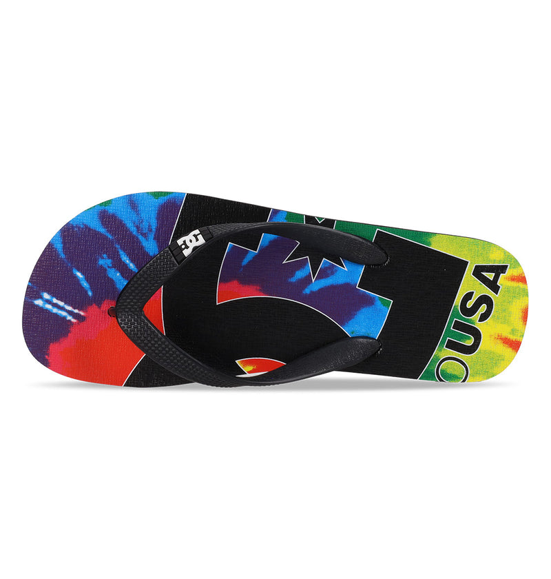 The Men's Spray Graffik Slides by DC Shoes feature a vibrant tie-dye design with black straps and “USA” on the sole—ideal for your next skate session.