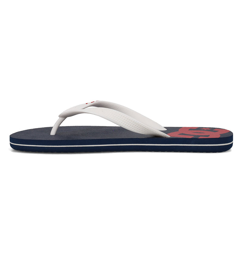 The DC Shoes Men's Spray Slides is a single navy blue slip-on sandal with white straps and a red design on the footbed, shown in side profile against a white background.