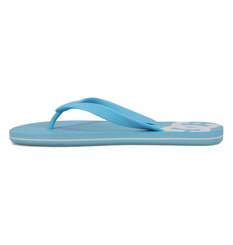 The DC Shoes Men's Spray Slides are light blue flip-flop sandals with a textured thong strap, flat sole, and a partial white logo on the heel—must-have slides perfect for relaxing after a skate session.
