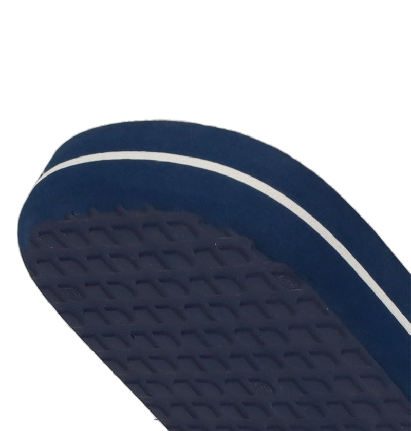 Close-up of the sole of DC Shoes Men's Spray Slides in navy blue, featuring a white side stripe and textured tread—ideal for your next skate session.