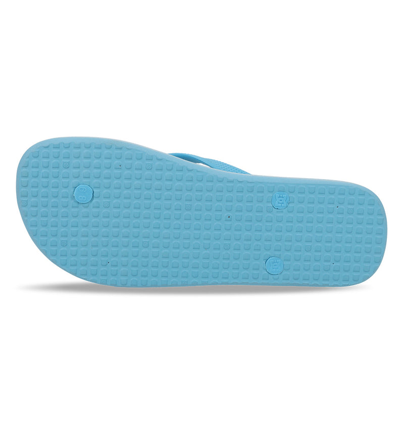 The image shows the bottom view of the Men's Spray Slides by DC Shoes, featuring a light blue textured sole with a grid pattern and three visible plugs—ideal for sliding on after a skate session.