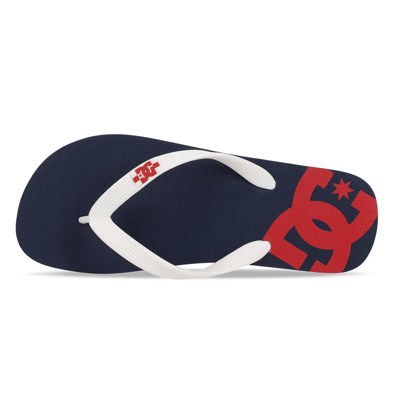 The Men's Spray Slides by DC Shoes feature a navy blue slip-on design with a white textured strap and a bold red DC Shoes logo on the footbed—essential slides for any skate session.