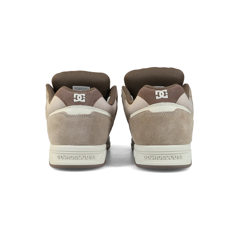The Men's Stag Shoes by DC Shoes are shown from the back in brown and beige, featuring suede and mesh uppers, a durable cupsole, DC branding on heel and tongue, oversized puff accents, and padded collars.