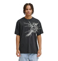 A young man with braided hair wears the Reebok Strike Twice Hss—a loose black t-shirt with a bold, abstract white graphic and text—standing facing forward, arms relaxed at his sides against a plain white background.