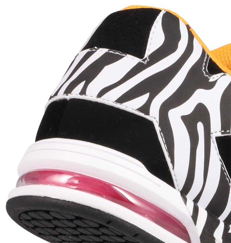 Close-up of the heel on the Women's DC Command Shoes by DC Shoes, highlighting the black and white zebra pattern, white midsole, pink air cushion, and a yellow fabric accent for bold street style.