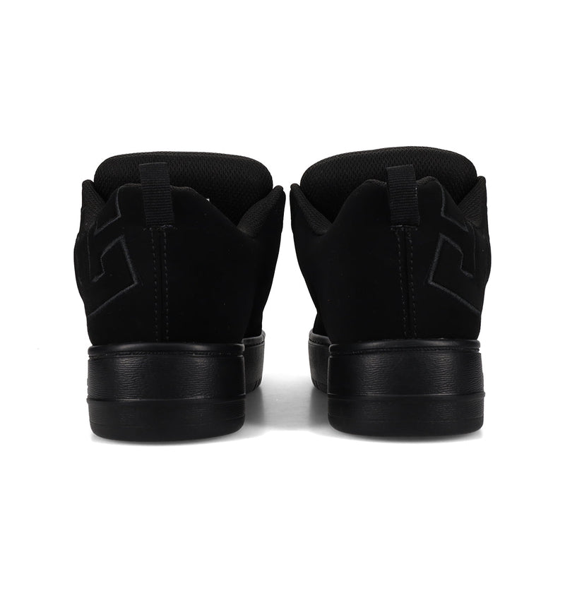 A pair of Women's Court Graffik Platform Shoes by DC Shoes in black suede, seen from the back with padded heels, tonal stitching, and a subtle embossed side design—a signature style for women's collections.