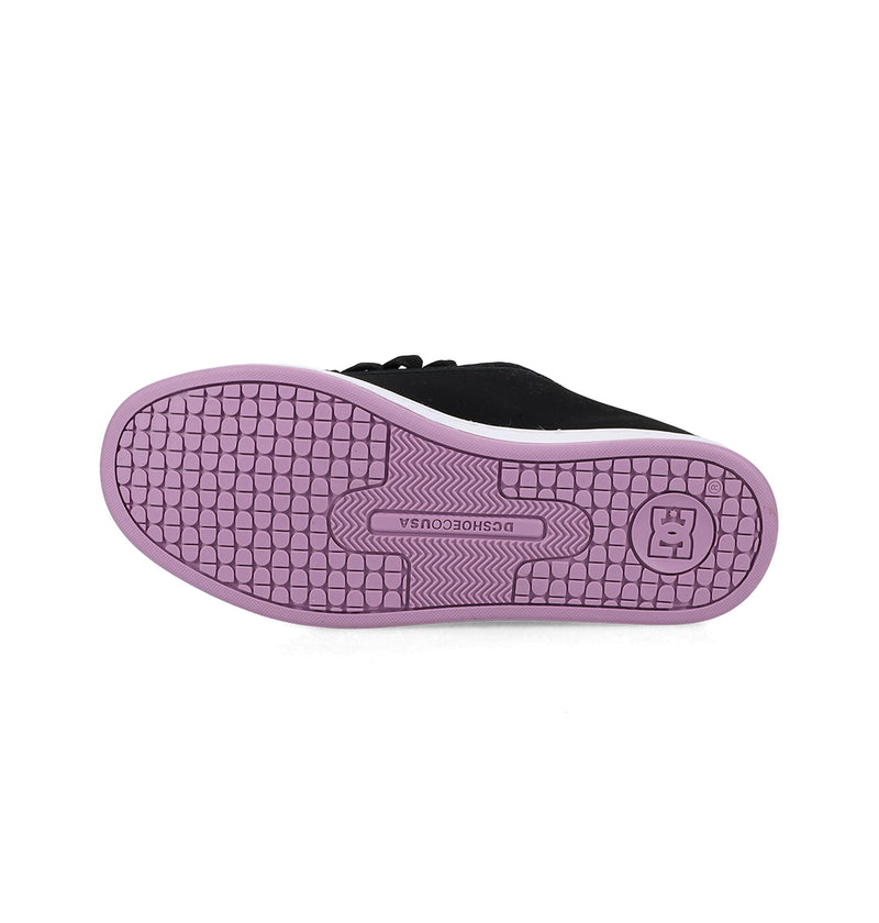The image displays the sole of DC Shoes Women's Court Graffik Shoes, featuring a black, chunky design with a textured pattern and light purple rubber outsole. The DC Shoes logo and "DCSHOECOUSA" are embossed near the center, evoking '90s style.
