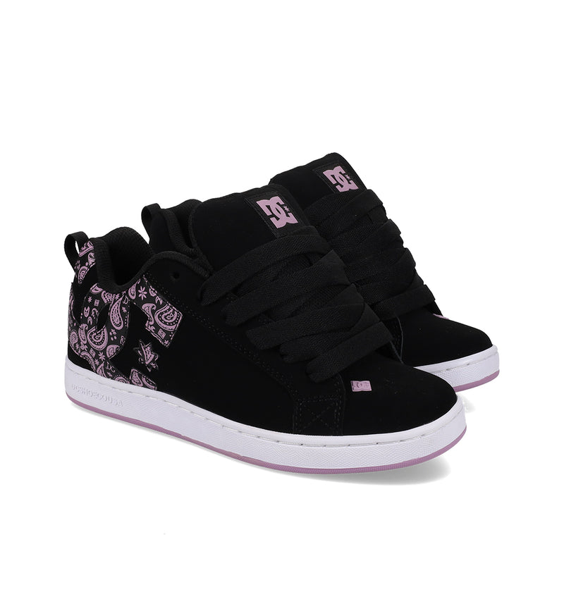 The Women's Court Graffik Shoes by DC Shoes are black skate shoes with thick black laces, purple paisley side details, white soles with a purple trim, chunky '90s style, and feature the DC logo on the tongue and side.