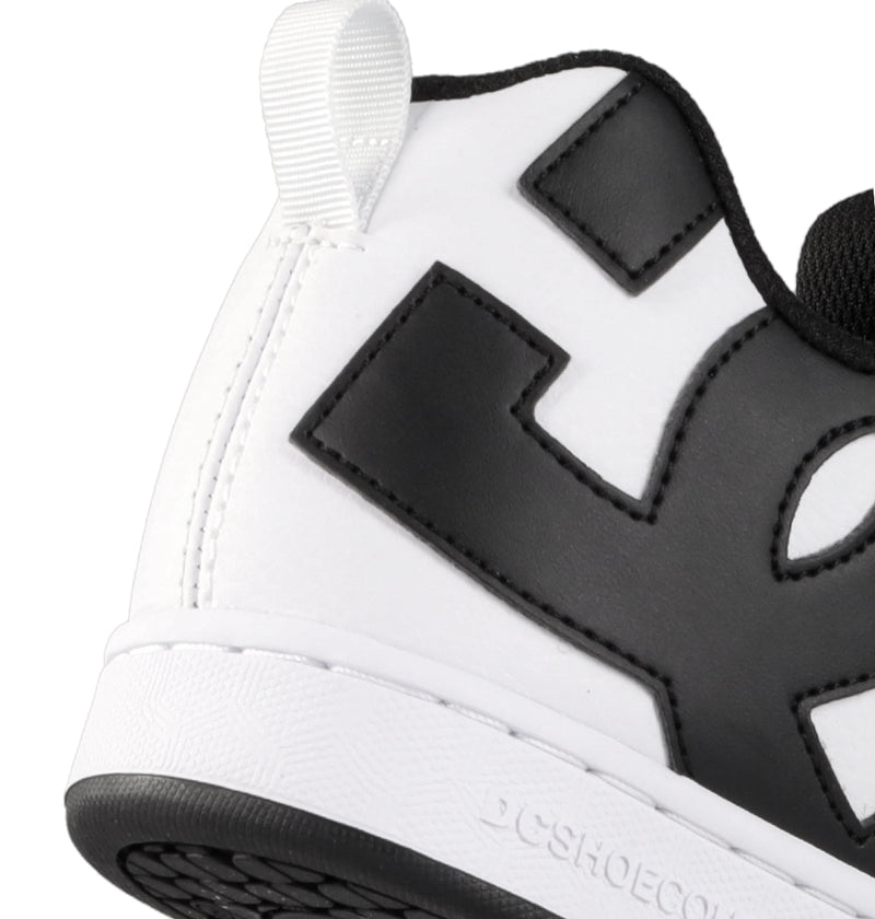 Close-up of the back and side of DC Shoes Women's Court Graffik, a white chunky sneaker with a large black "E," black lining, white pull tab, and textured white sole with black tread—perfect for adding '90s style to your collection.