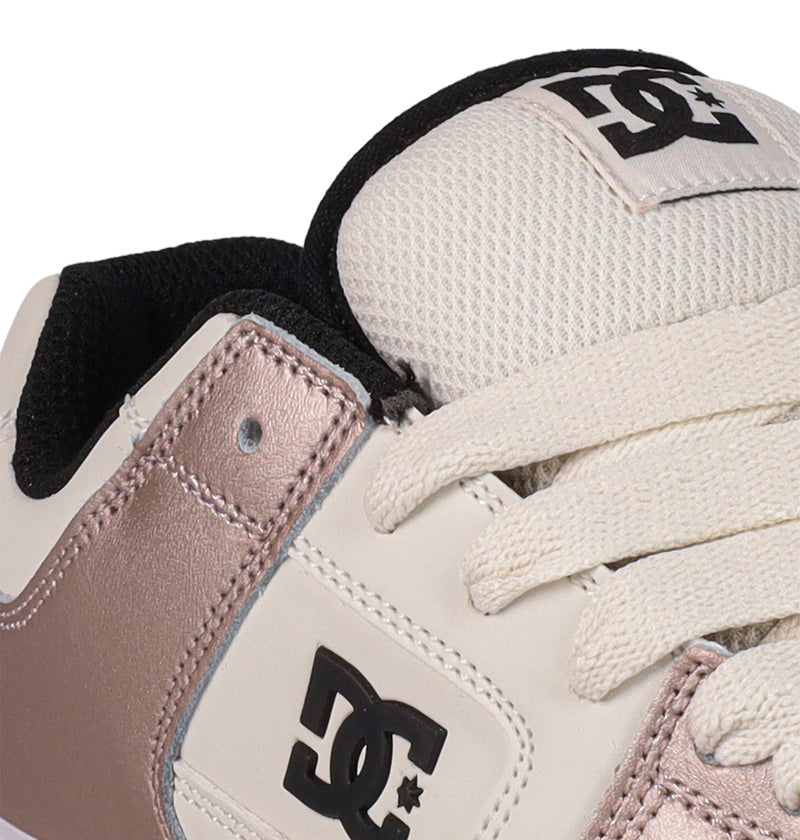 Close-up of DC Shoes Women's Manteca 4 Shoes with cream laces, black and white DC logo on tongue and side, plus metallic rose gold and white panels.
